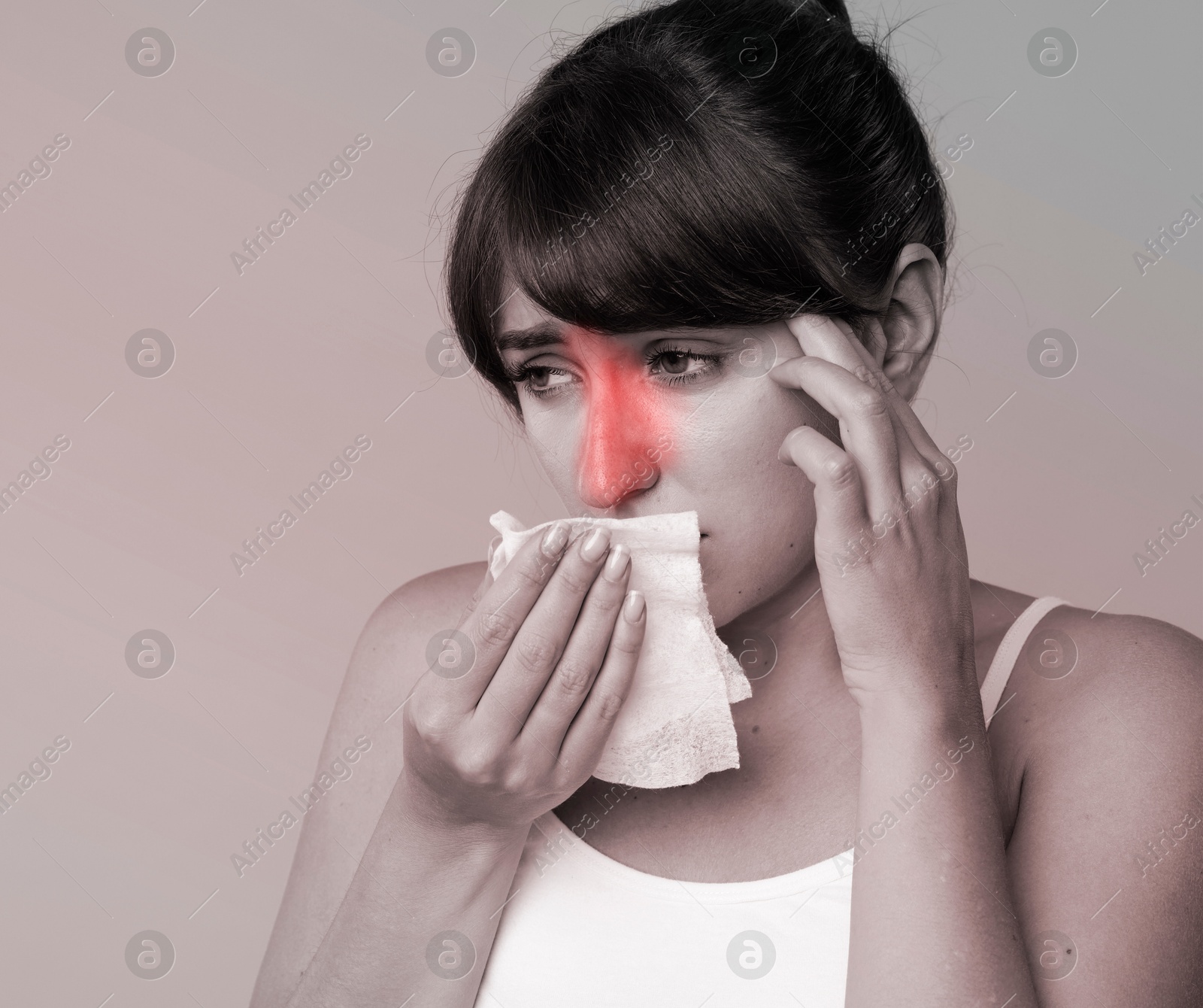 Image of Woman with tissue suffering from sinusitis. Black and white effect with red color accent