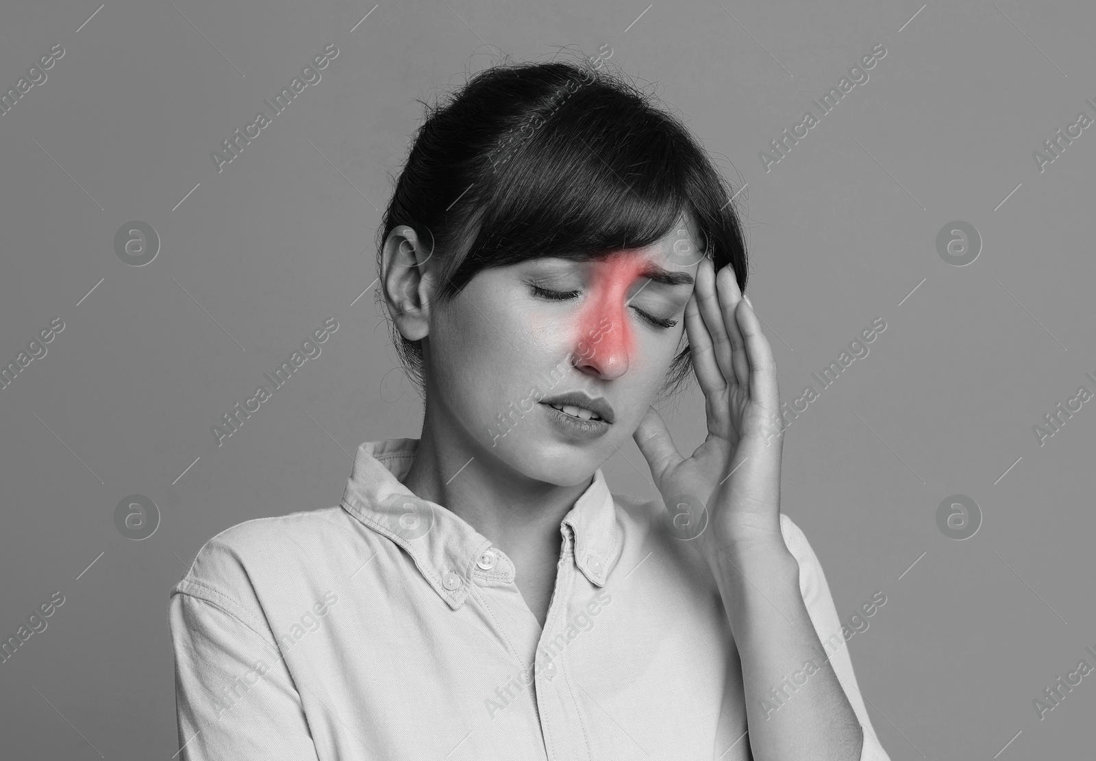 Image of Woman suffering from sinusitis. Black and white effect with red color accent