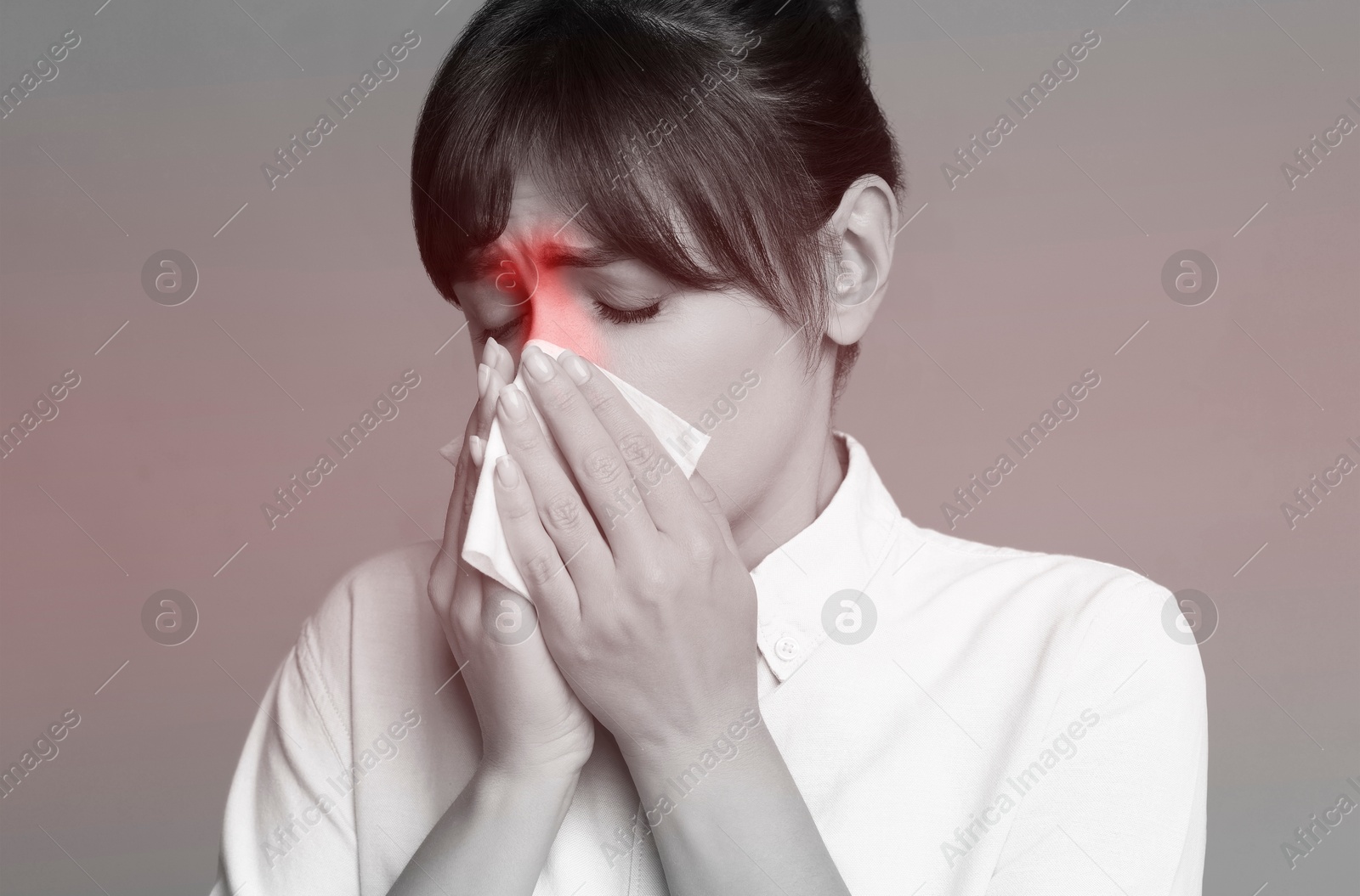 Image of Woman with tissue suffering from sinusitis. Black and white effect with red color accent