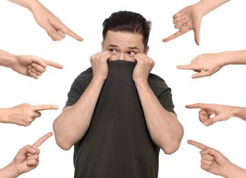 People pointing at embarrassed man on white background