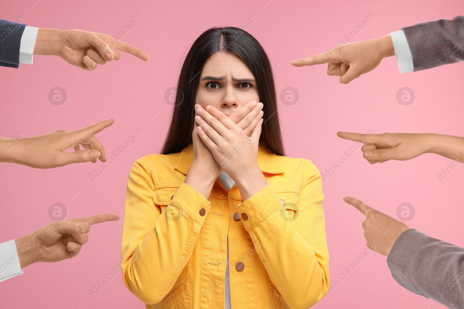 Image of People pointing at embarrassed woman on pink background