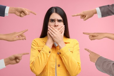 People pointing at embarrassed woman on pink background