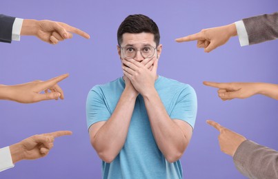 People pointing at embarrassed man on violet background