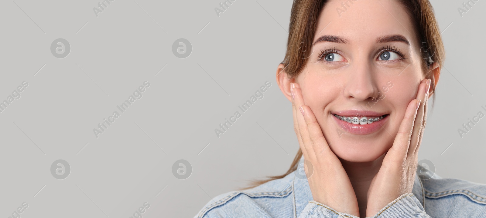 Image of Beautiful woman with braces smiling on light background. Banner design with space for text