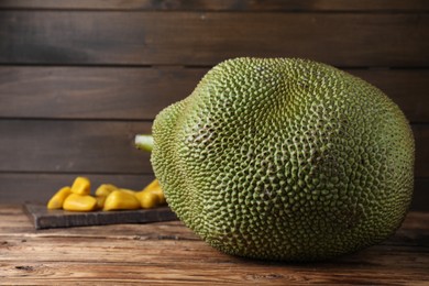 Photo of Fresh raw exotic jackfruit on wooden table