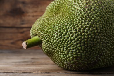 Photo of Fresh exotic jackfruit on wooden table, closeup