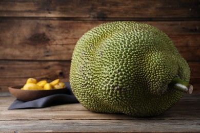 Photo of Fresh raw exotic jackfruit on wooden table