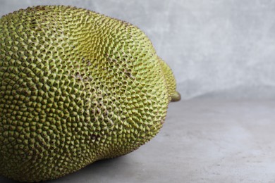 Photo of Delicious exotic jackfruit on light grey table. Space for text