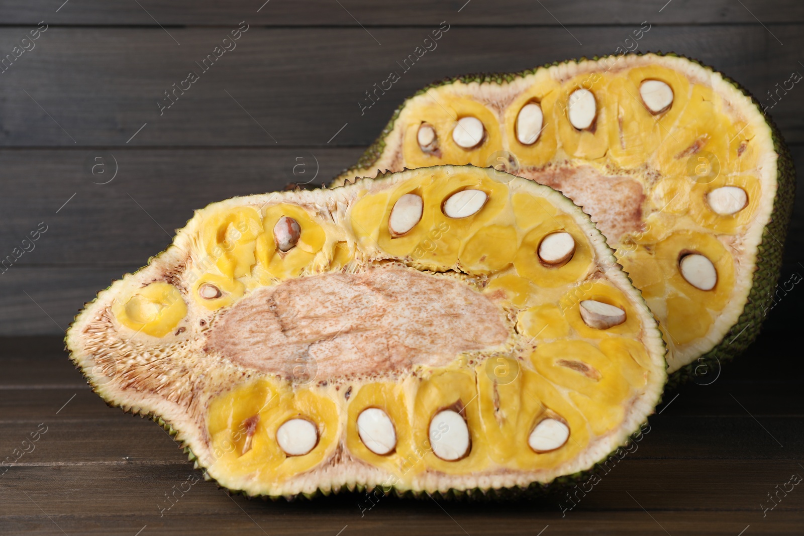 Photo of Delicious cut exotic jackfruit on wooden table