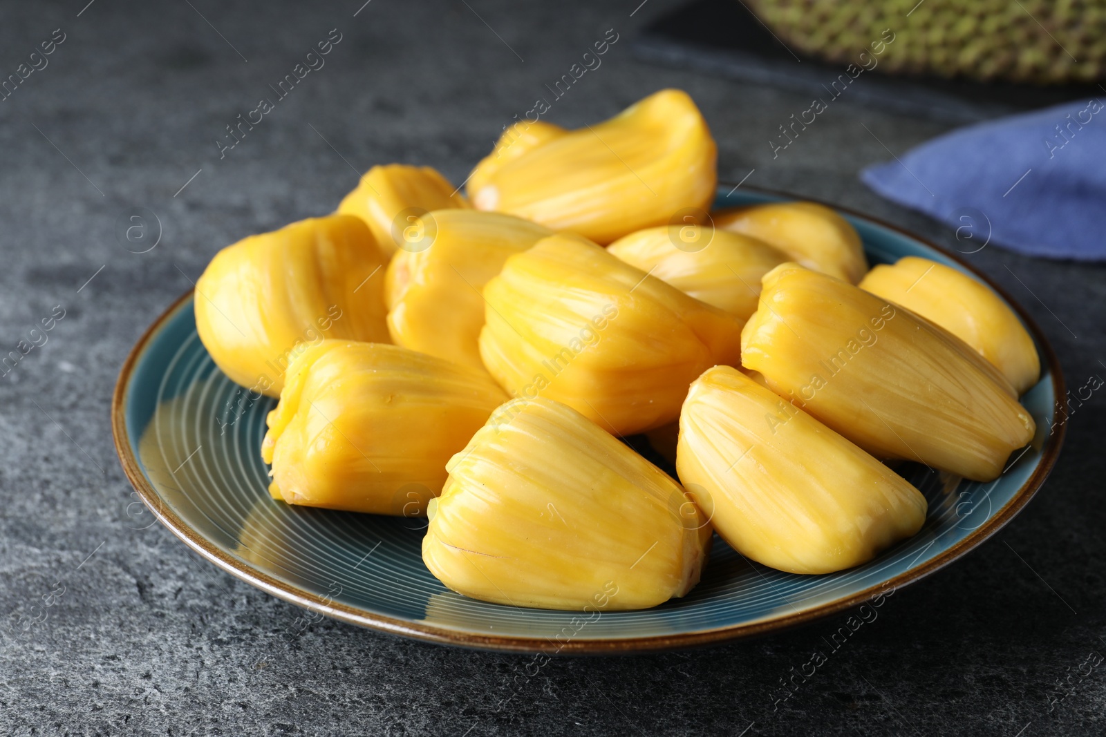 Photo of Fresh exotic jackfruit bulbs on grey table