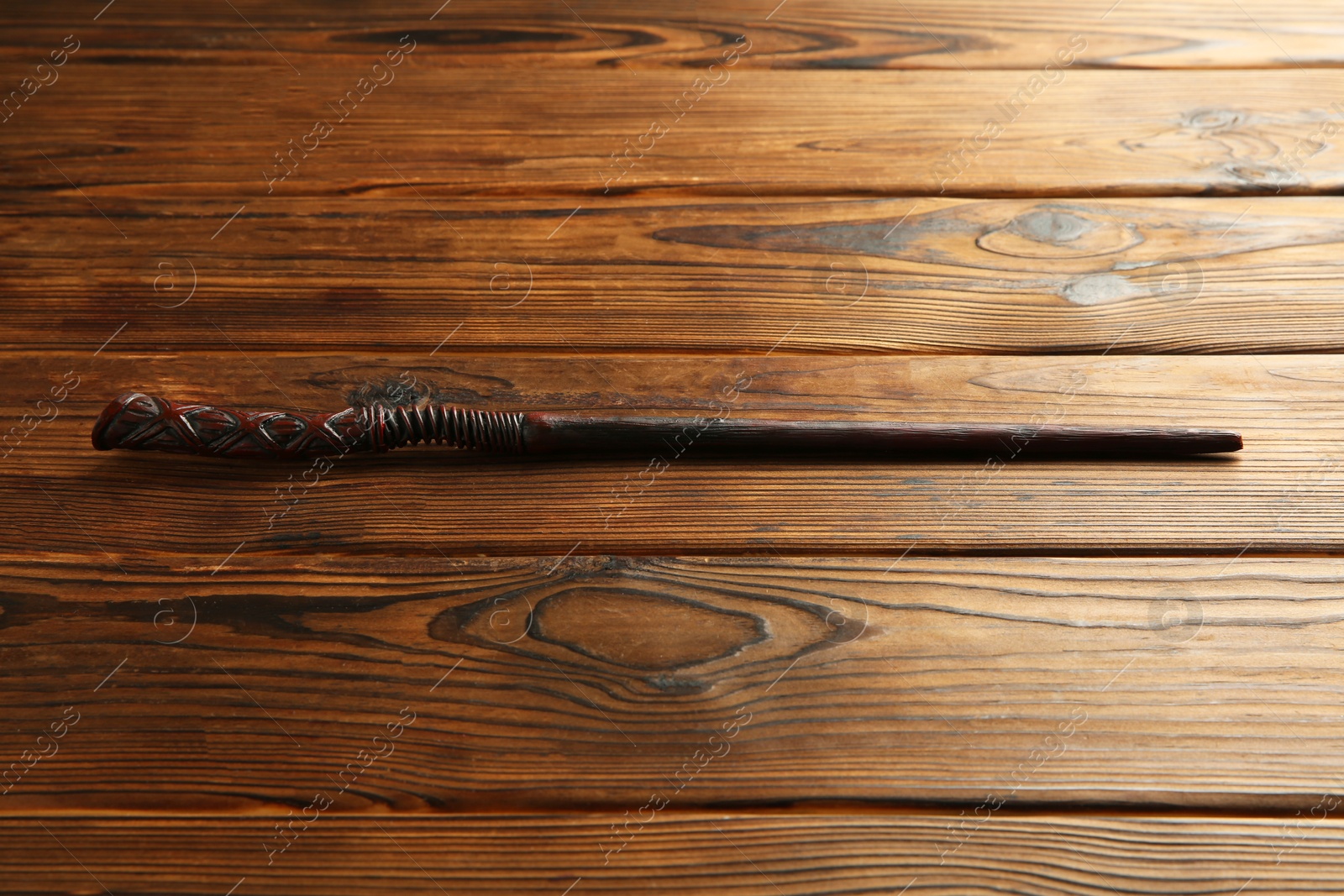 Photo of One old magic wand on wooden table