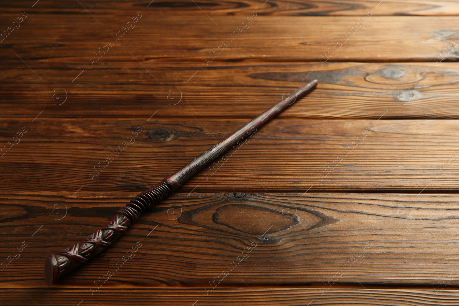 Photo of One old magic wand on wooden table