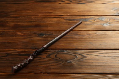 Photo of One old magic wand on wooden table