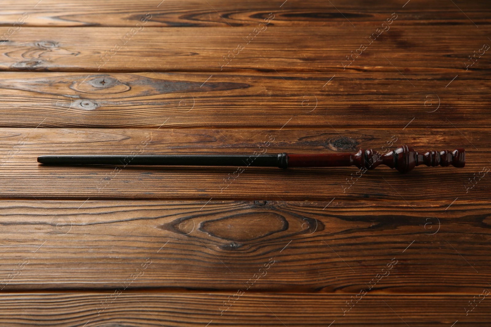 Photo of One old magic wand on wooden table