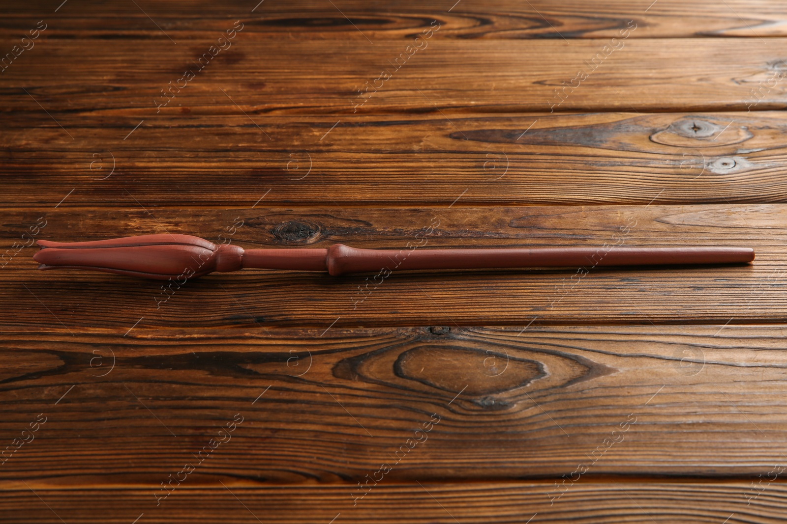 Photo of One old magic wand on wooden table