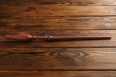 Photo of One old magic wand on wooden table