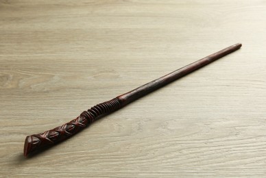 Photo of One magic wand on light wooden table