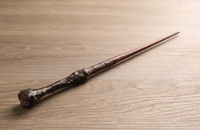 Photo of One magic wand on light wooden table