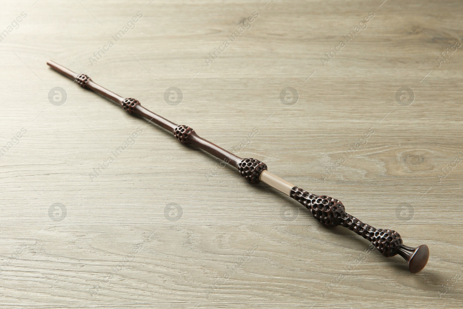 Photo of One magic wand on light wooden table