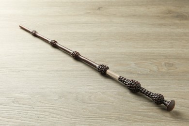 Photo of One magic wand on light wooden table