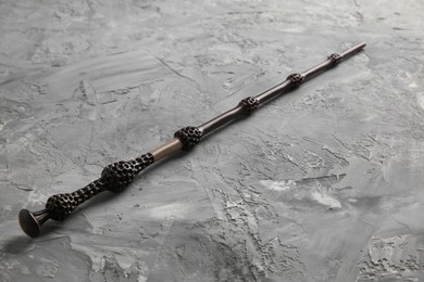 Photo of One magic wand on grey textured table