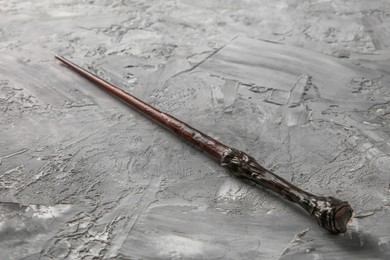 Photo of One magic wand on grey textured table