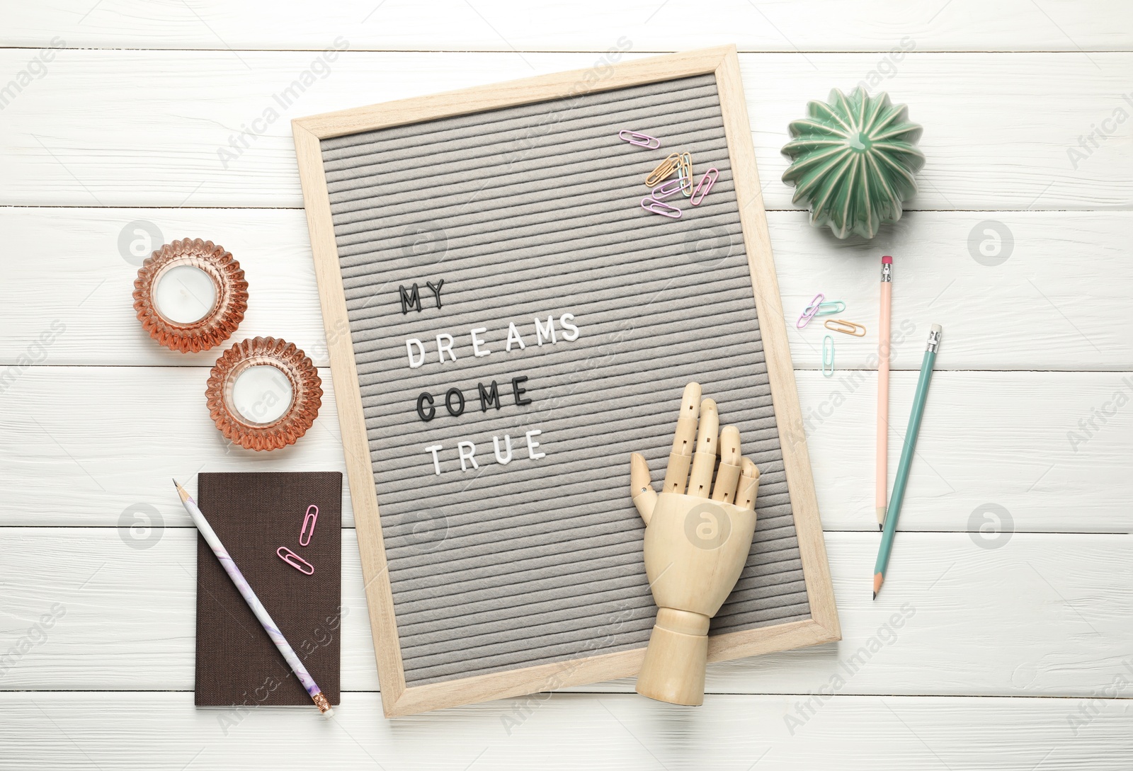 Photo of Flat lay composition of letter board with phrase My Dreams Come True on white wooden table