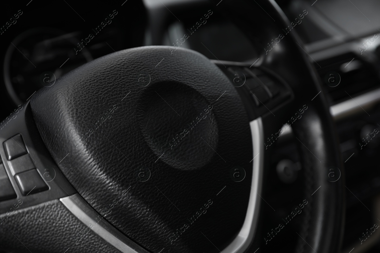 Photo of Steering wheel inside modern car, closeup view