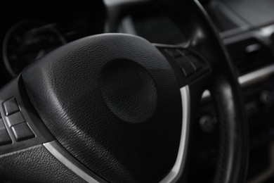 Photo of Steering wheel inside modern car, closeup view