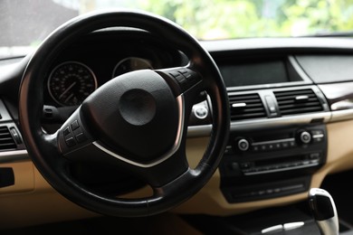 Photo of Steering wheel in modern car, view from inside