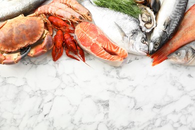 Photo of Different sea food on white table, top view. Space for text