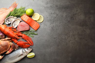 Different sea food on grey table, flat lay. Space for text