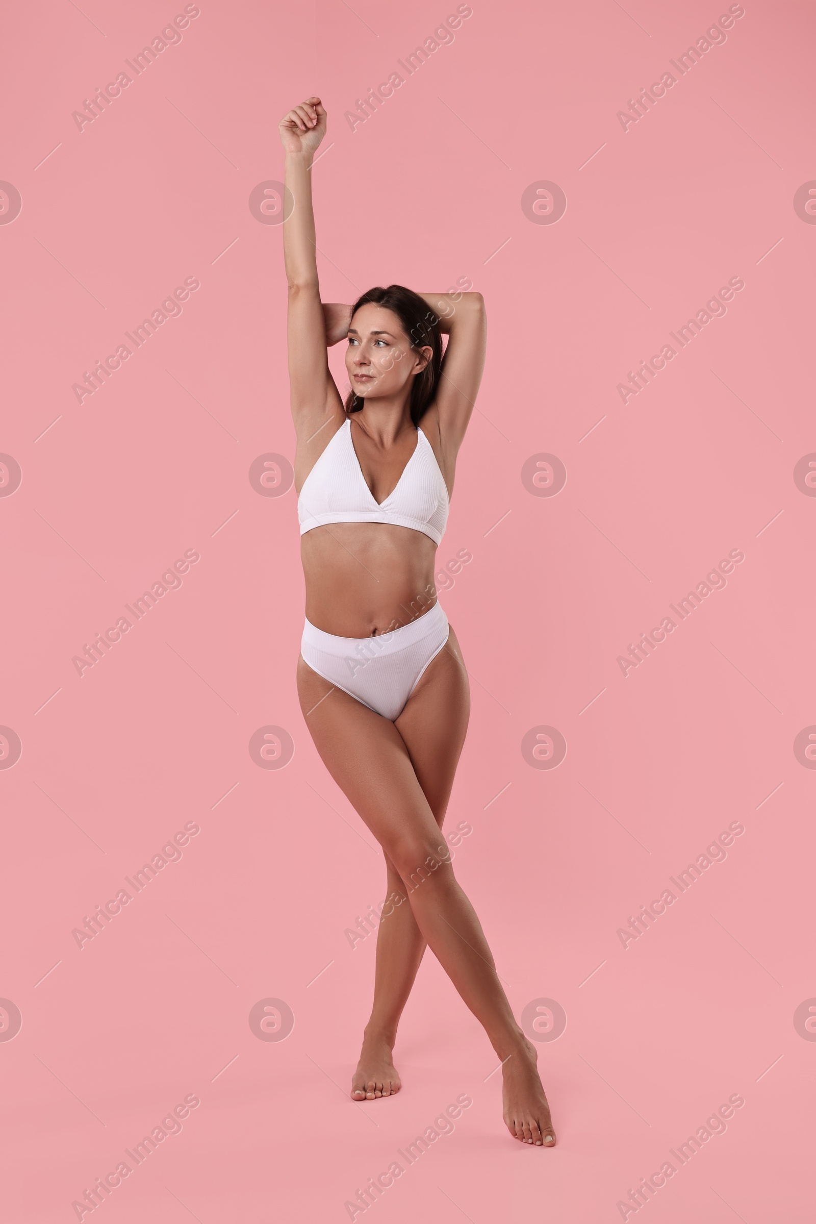 Photo of Beautiful woman with perfect skin on pink background. Body care