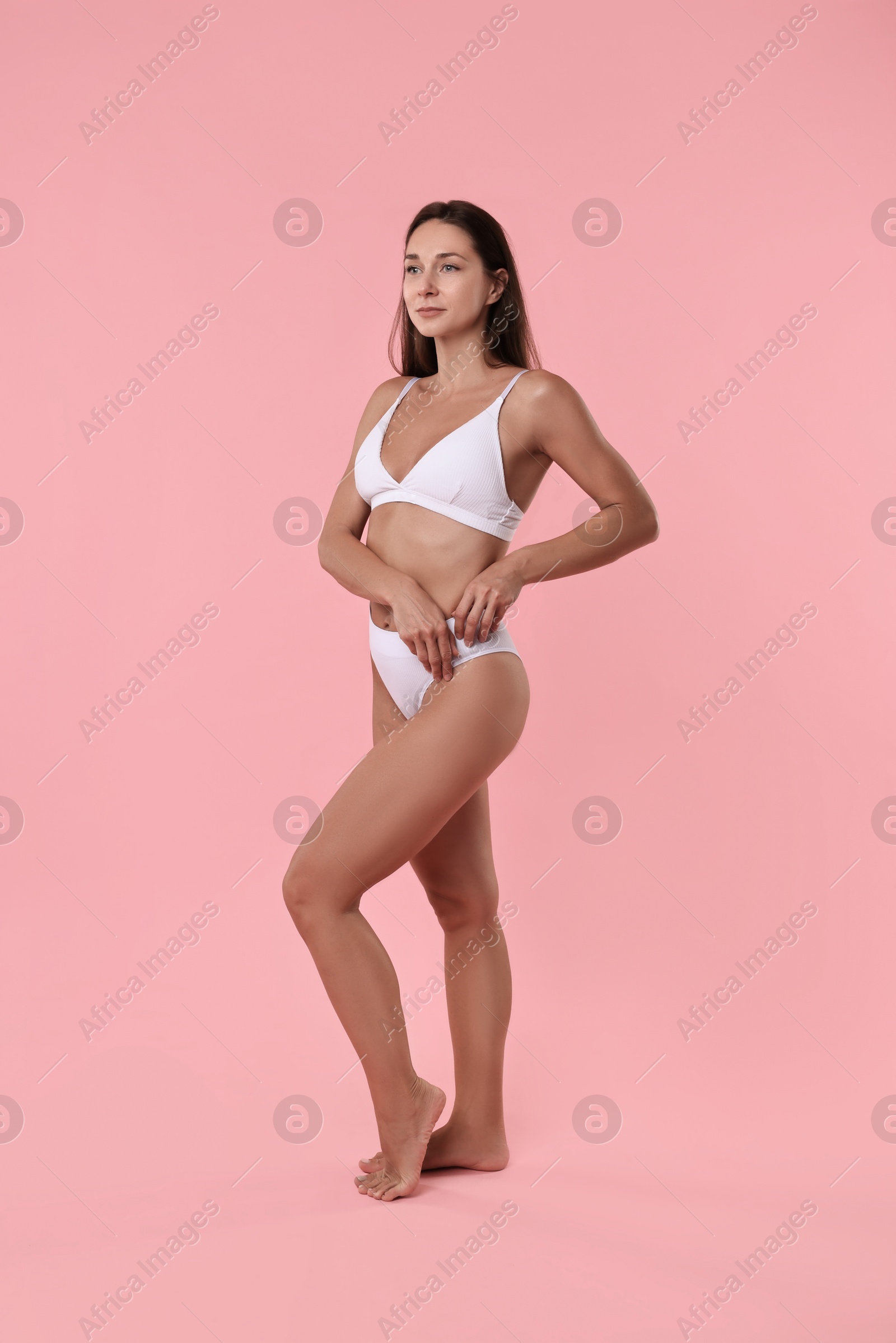 Photo of Beautiful woman with perfect skin on pink background. Body care