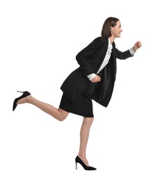 Photo of Young businesswoman in suit running on white background