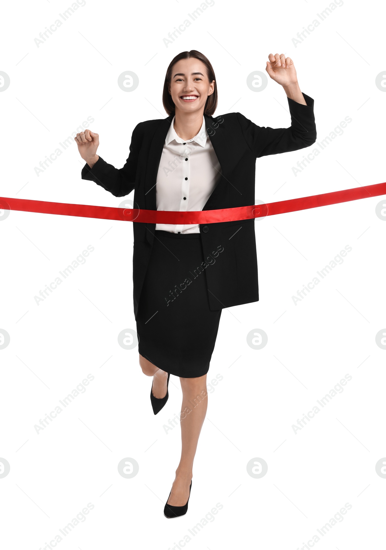 Photo of Young businesswoman in suit crossing red finish line on white background