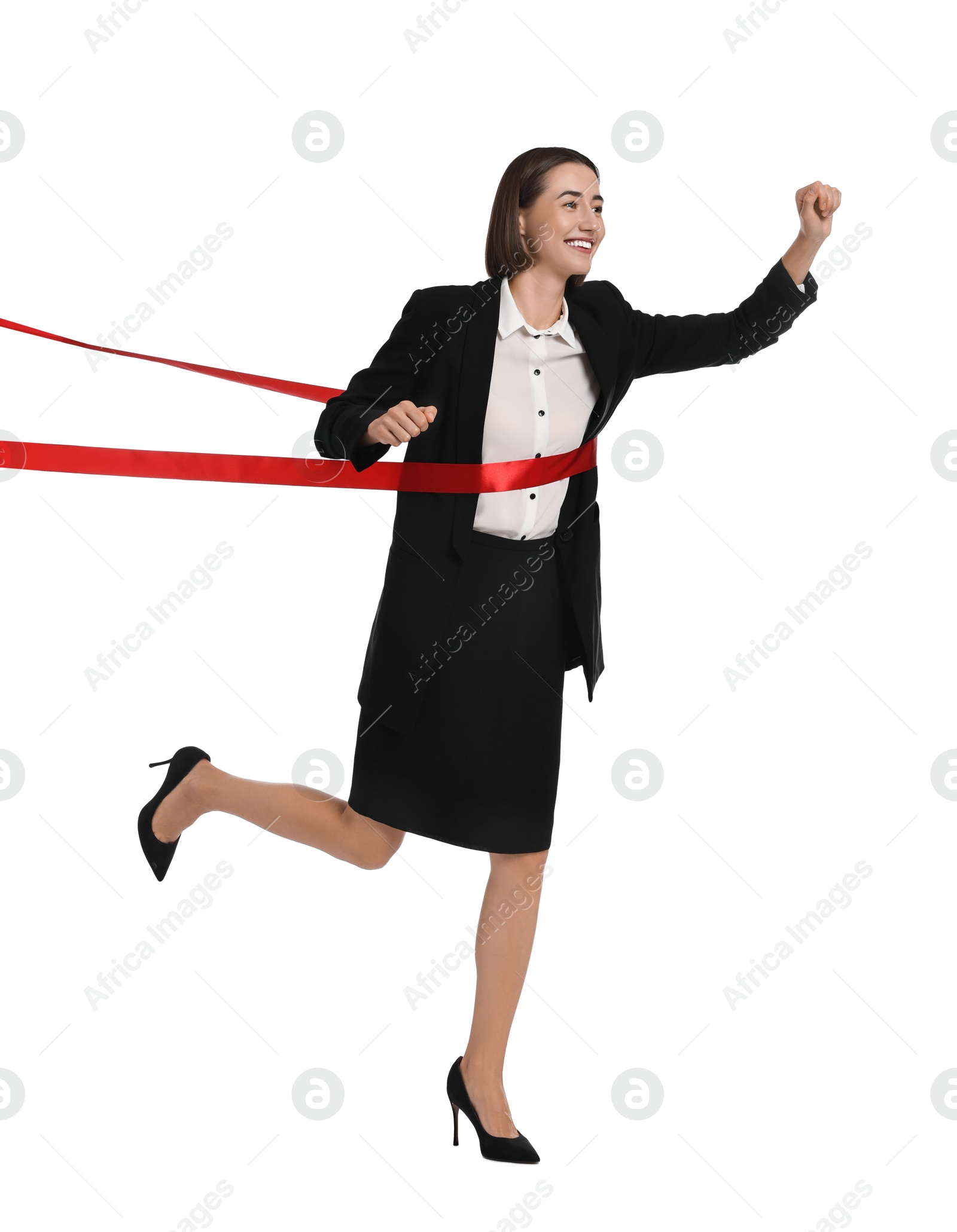 Photo of Young businesswoman in suit crossing red finish line on white background