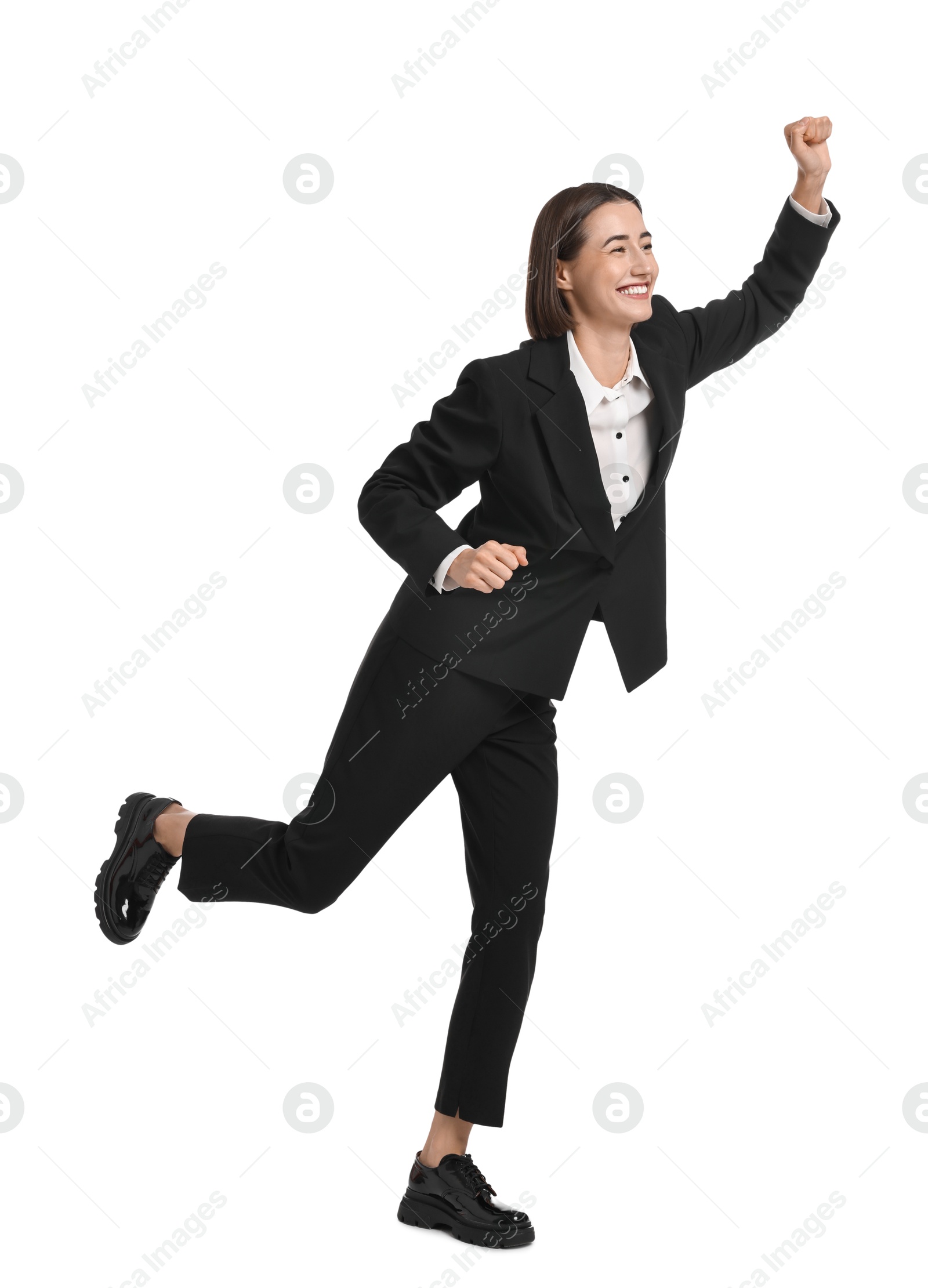 Photo of Young businesswoman in suit running on white background