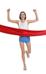 Beautiful woman in sportswear crossing red finish line on white background