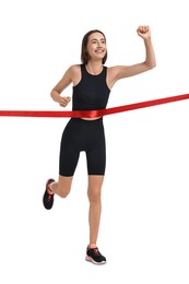 Photo of Beautiful woman in sportswear crossing red finish line on white background