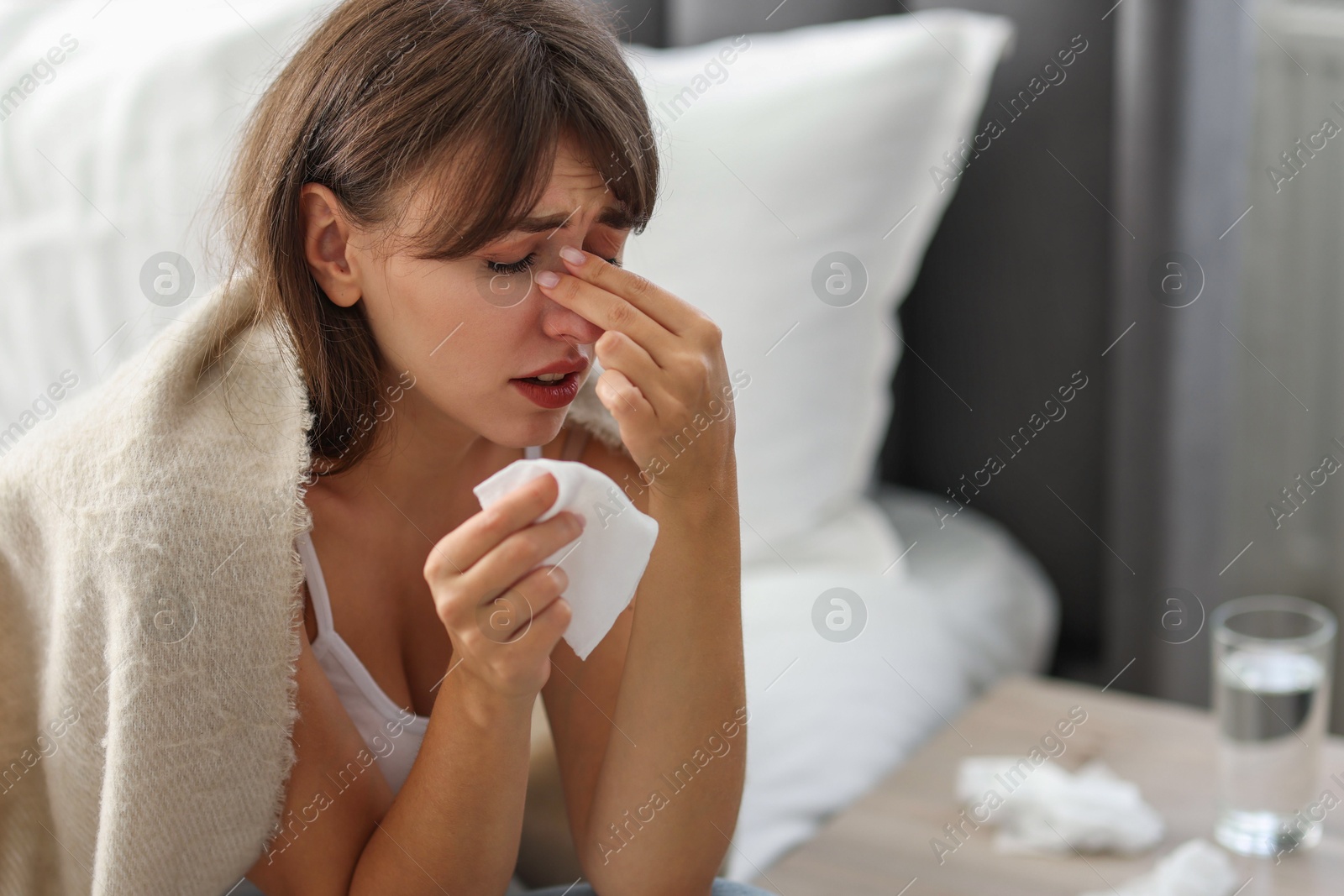 Photo of Woman wrapped in blanket suffering from sinusitis at home. Space for text