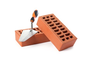 Photo of Red bricks and trowel on white background