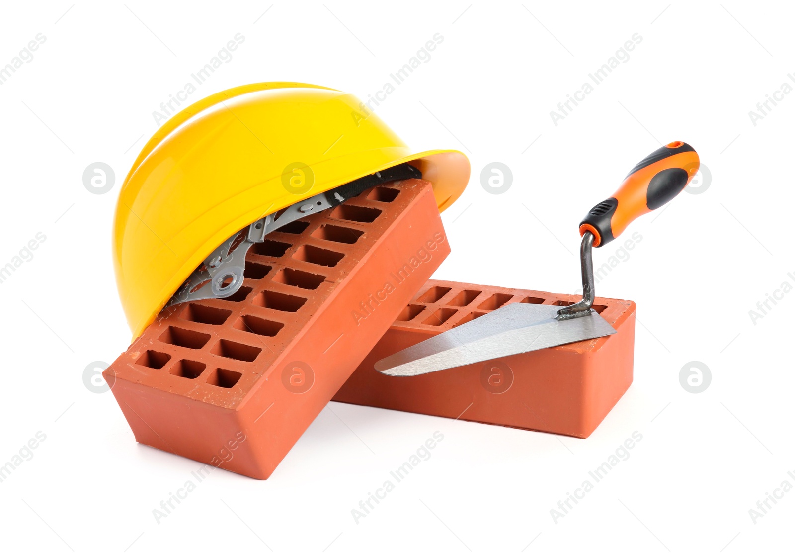 Photo of Red bricks, hard hat and trowel on white background