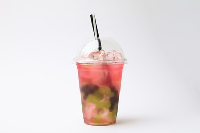 Photo of Tasty bubble tea in plastic cup on white background