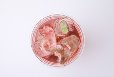 Photo of Tasty bubble tea in plastic cup on white background, top view