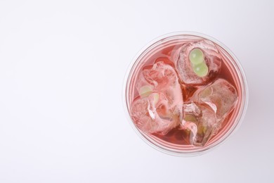 Photo of Tasty bubble tea in plastic cup on white background, top view. Space for text