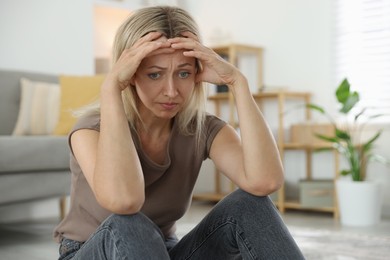 Menopause. Woman suffering from headache at home