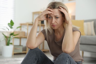 Photo of Menopause. Woman suffering from headache at home