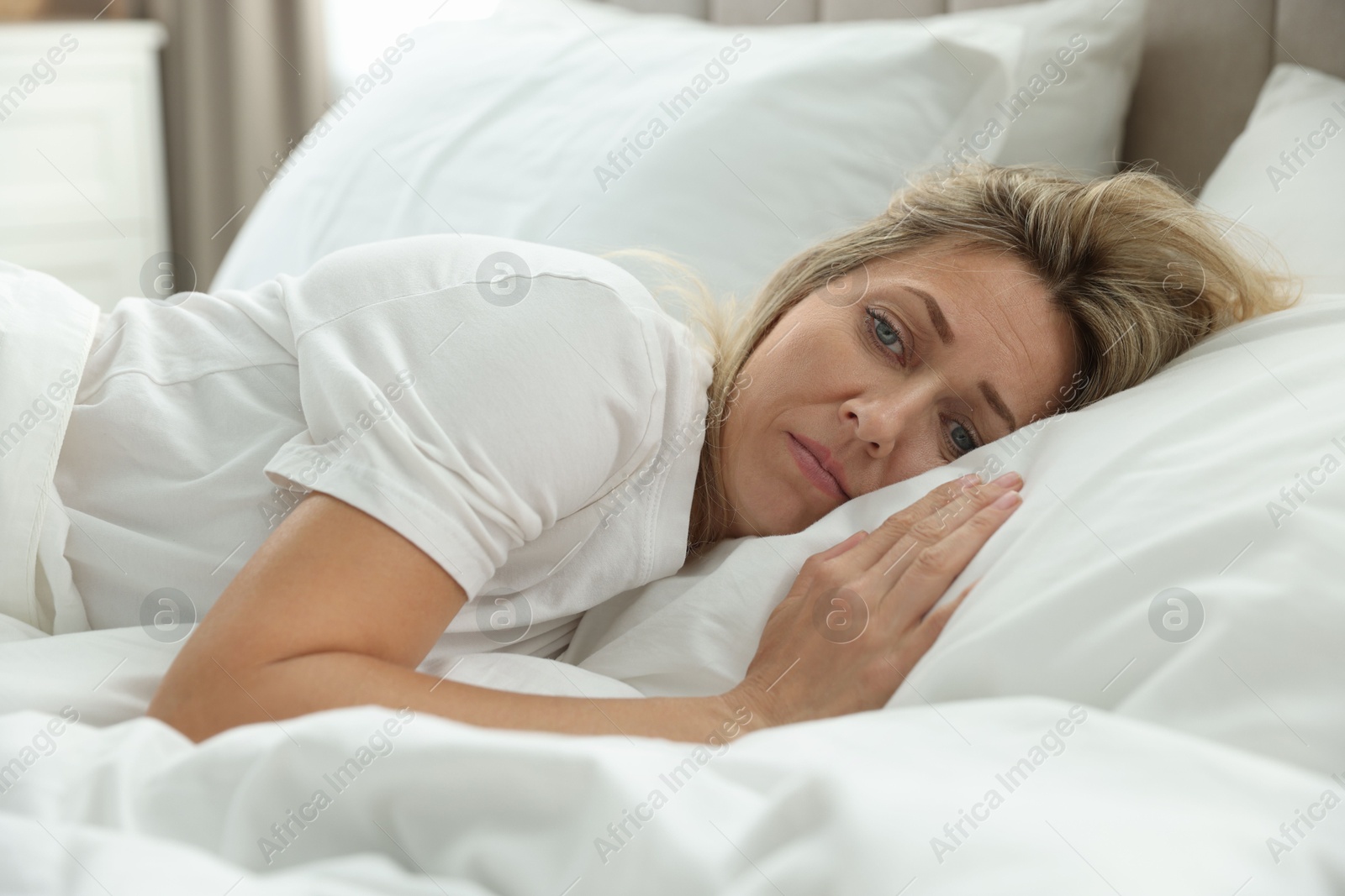 Photo of Menopause, sleep problems. Woman suffering from insomnia in bed indoors