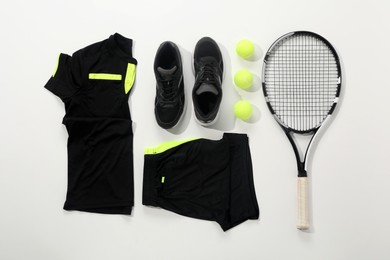 Photo of Tennis racket, balls and sportswear on white background, flat lay